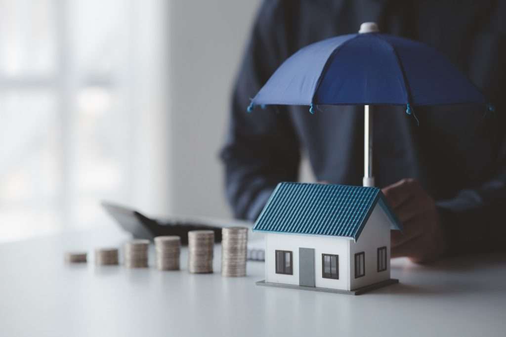 What Is Dwelling Insurance individuals holding small umbrellas and model homes housing insurance against impending loss and fi 1024x682 - What Is Dwelling Insurance